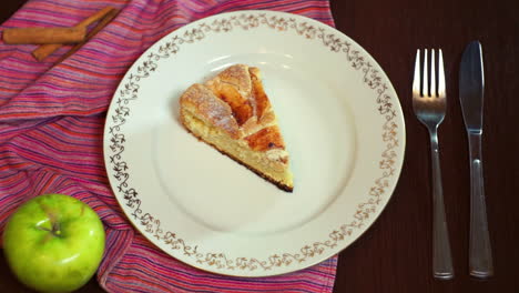 cook putting cake slice on plate. homemade apple cake. piece of cake on dish