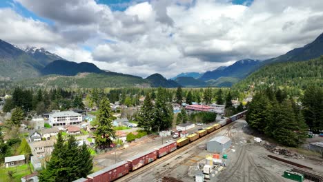 cargo trains on the railway surrounded by mountains in hope, british columbia, canada