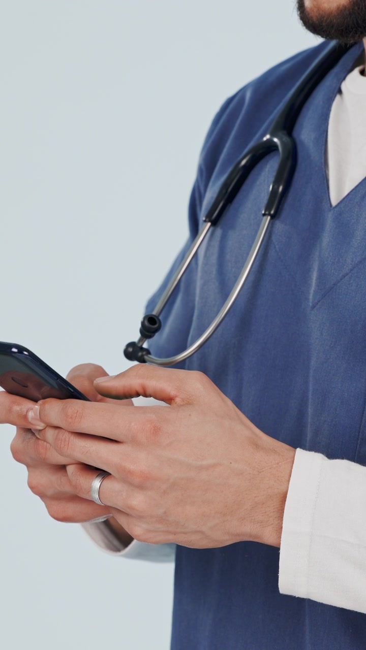 Médico usando un smartphone en un entorno hospitalario.