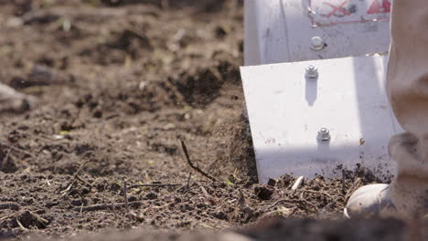 A-rototiller-working-the-land-in-Sweden,-agriculture,-slow-motion-close-up