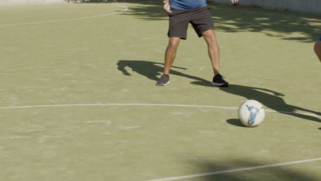 medium shot of senior sportsmen playing football in the stadium