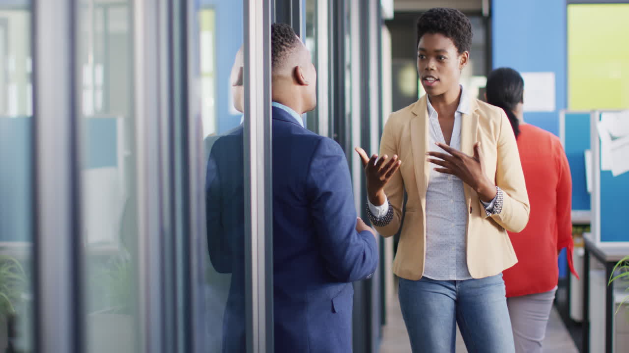 African american business people discussing work at office, slow motion