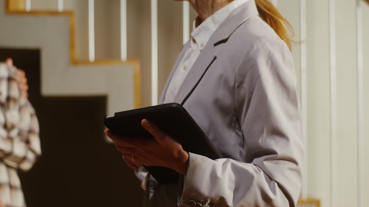 Businesswoman using tablet on stairs