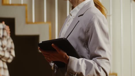businesswoman using tablet on stairs