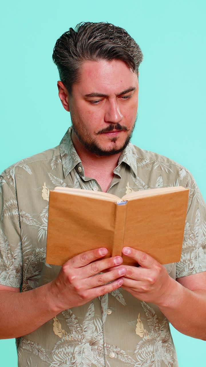 Man reading book with raised eyebrows showing surprise or interest in unexpected story twist moment