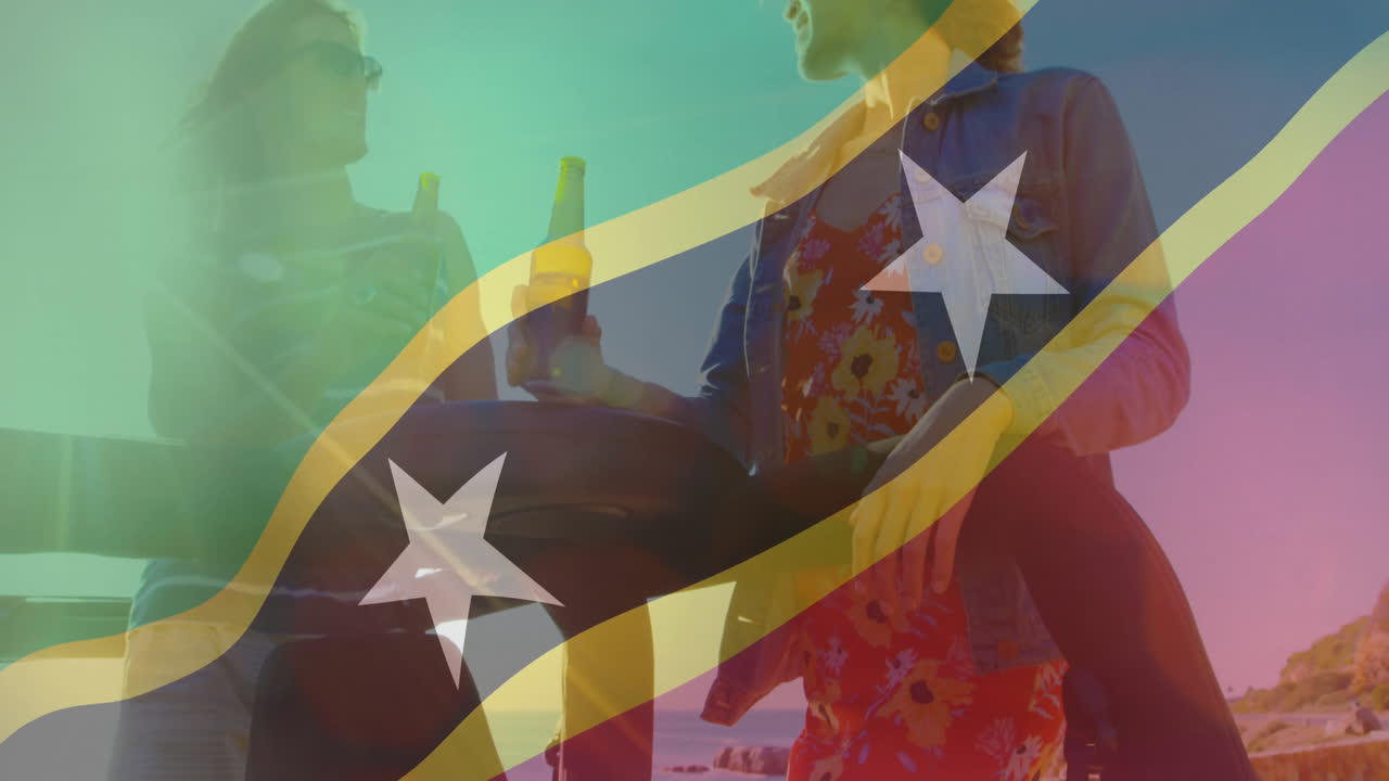 At beach, two people holding drinks with colorful flag animation overlay