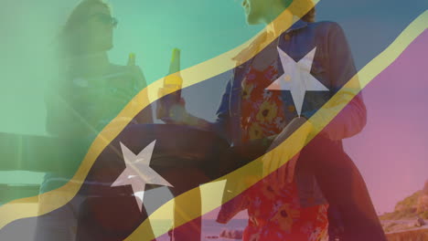 at beach, two people holding drinks with colorful flag animation overlay