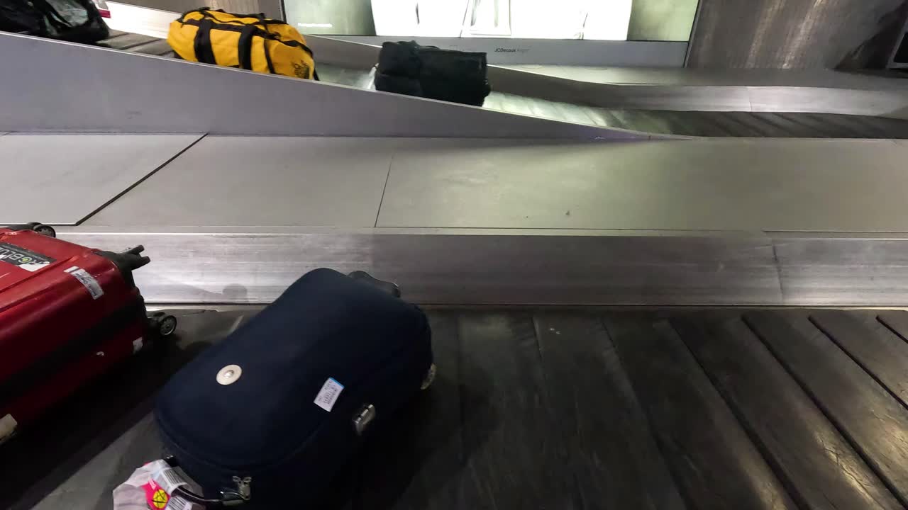 Suitcases moving on airport baggage carousel