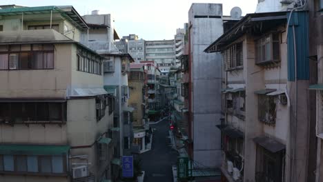 drone shot of a street in taipei city center, moving between narrow building