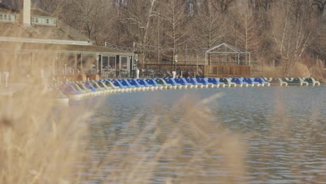 panning l to r of paddle boat harbor on empty lake