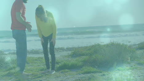 man and woman exploring coastal shore, showing marketing data overlay with animated wave chart