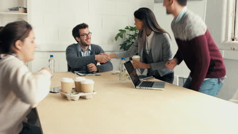 handshake at business meeting showing teamwork