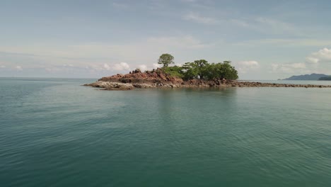 Imágenes-Aéreas-De-Drones-De-4k-Volando-Sobre-El-Agua-Y-Una-Isla-Aislada-Con-árboles-En-Tailandia