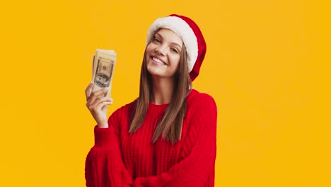 happy teenager with money in a santa hat