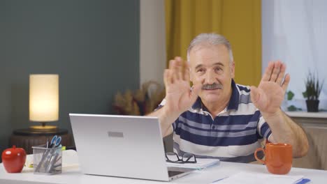 trabajador de oficina en casa anciano haciendo un gesto lindo en la cámara.