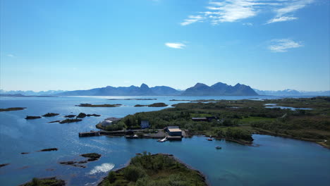 Arial-pan-shot-over-idyllic-Islands-on-a-nice-sunny-summer-day-in-Northern-Scandinavia,-Europe-Bo-I-Vesteralen---Beautiful-summer-to-the-sea