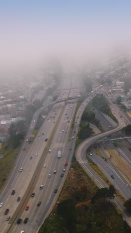 complexity of the highways in modern san francisco. urban panorama covered with thick white fog. vertical video