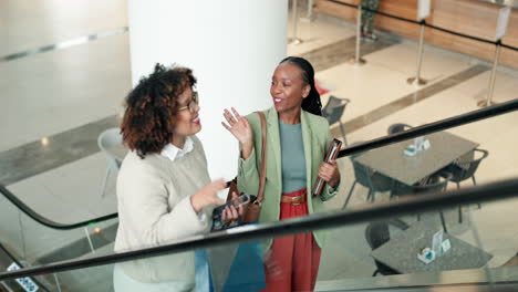 business women, talking and high five on escalator