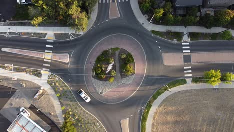 roundabout in a small town with cars driving around it