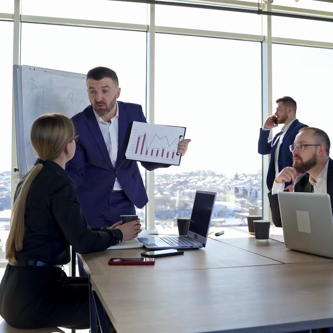 Group of happy young business people in a meeting at office. Teamwork, brainstorming concept