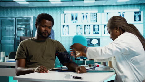 general practitioner measuring blood pressure with a blood pressure monitor