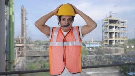 happy indian construction worker wearing the helmet