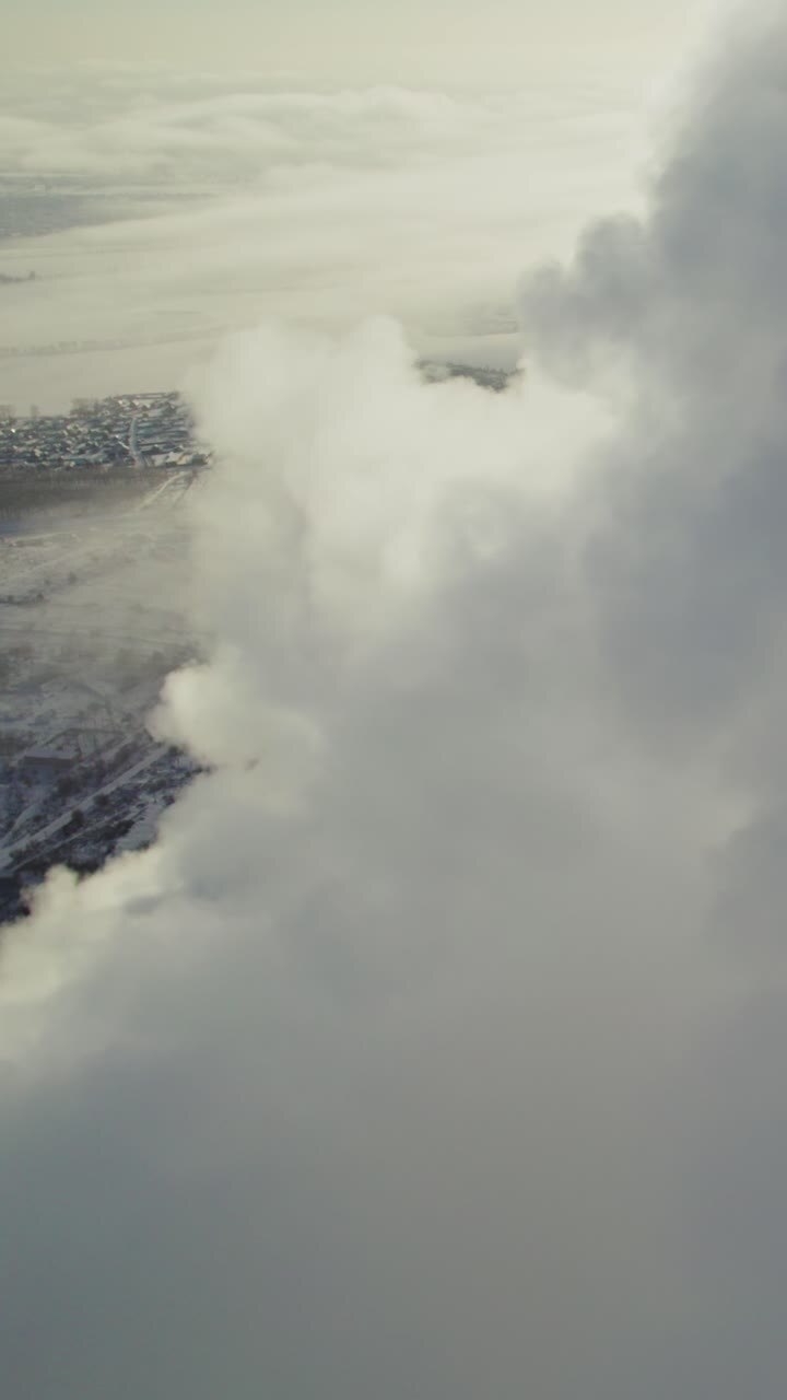 Aerial View of Clouds Over a Winter Landscape