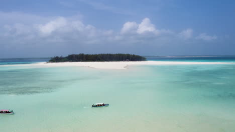 touristic boats anchoring in shallow tropical waters of mnemba atoll