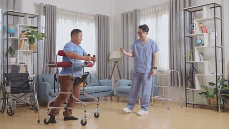 full body side view of asian male nurse making beckon hand gesture to a patient who use walker walking by himself then clapping his hands during a physical therapy at home