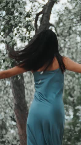 Woman in a blue dress amidst spring flowers