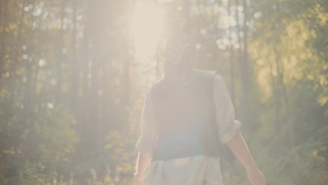 carefree female hiker enjoying vacation in forest