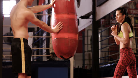 Female-boxer-practicing-with-trainer