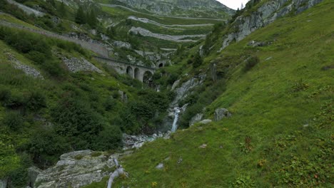 furka pass valley in switzerland with bridge and waterfalls