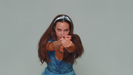 una chica bastante segura apuntando con el dedo un gesto de arma, tomando una decisión, disparando matando
