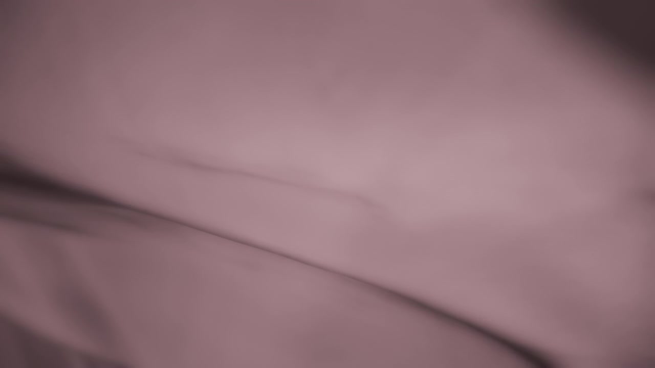 Light purple chiffon wavy fabric flowing in the wind. Slow motion