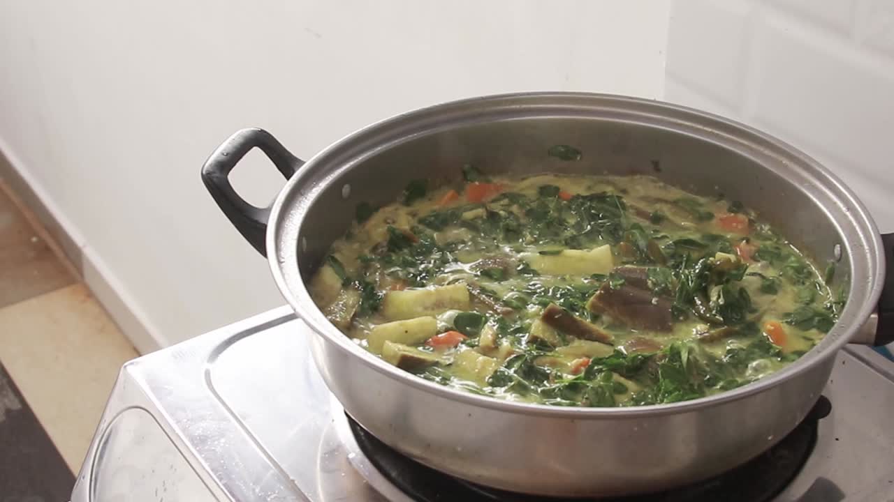 Premium stock video - A pot of simmering ginataang malunggay or moringa ...