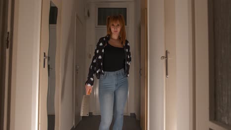 sexy beautiful and creepy girl standing in the dark hallway showing a cleaver