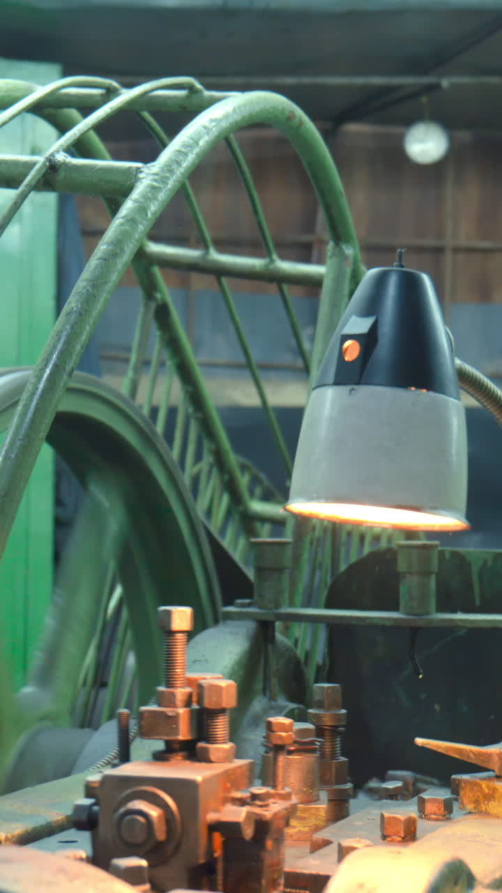 Vintage Industrial Machine Operating with Spinning Gear and Work Light