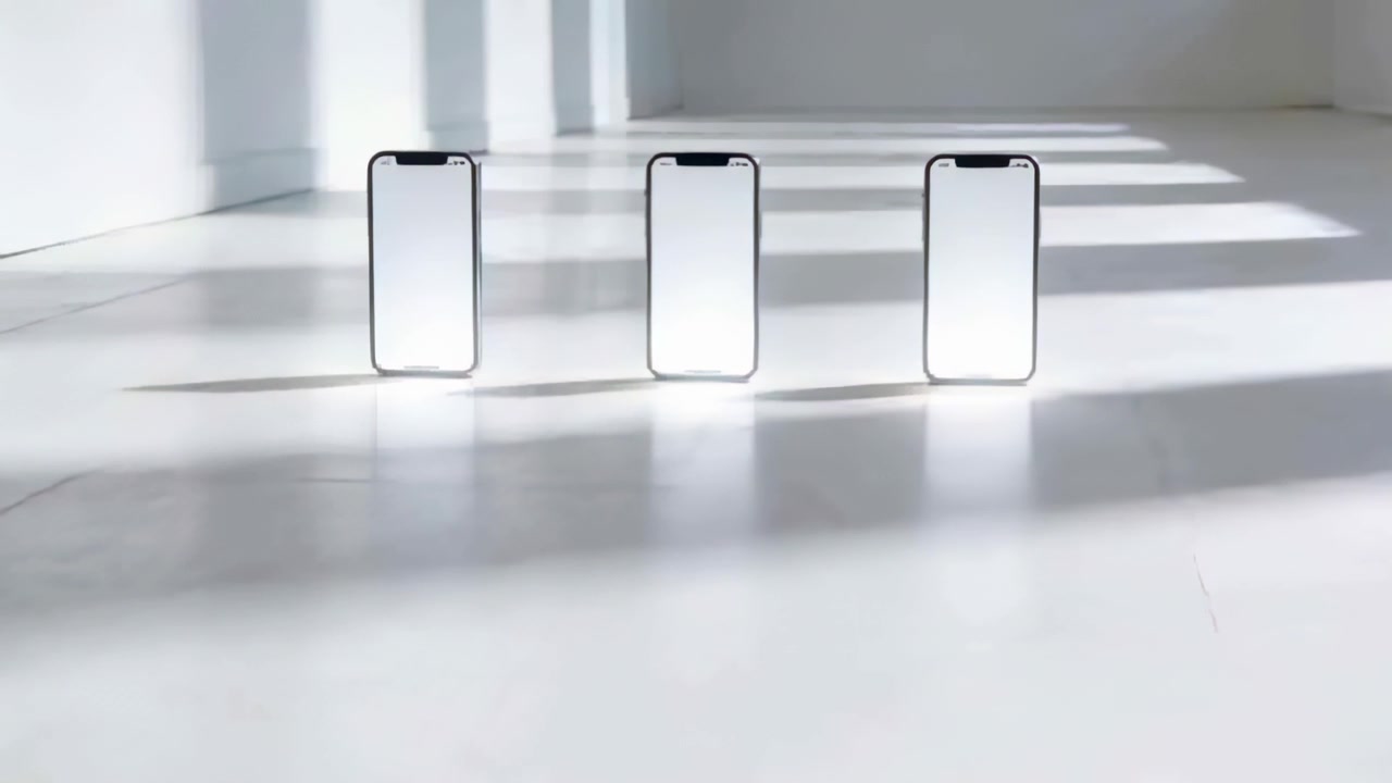 Streaming sunlight through studio windows, 3 smartphones casting bands on white floor, marking time