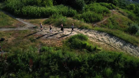 women running on a hilly trail