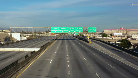 drone shot toward freeway signs at the closed interstate 10 in sunny los angeles