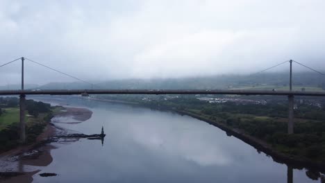 Cars-Driving-over-Erskine-Bridge-on-River-Clyde-in-Scotland,-Gateway-to-the-Highlands---Aerial-Drone-4K-HD-Footage,-Zoom-Out