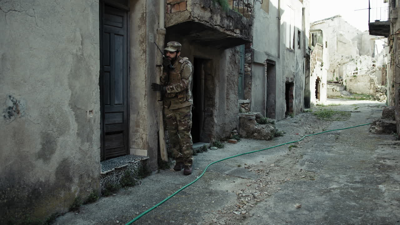 Soldier Communicates With Walkie Talkie Before Raiding A House