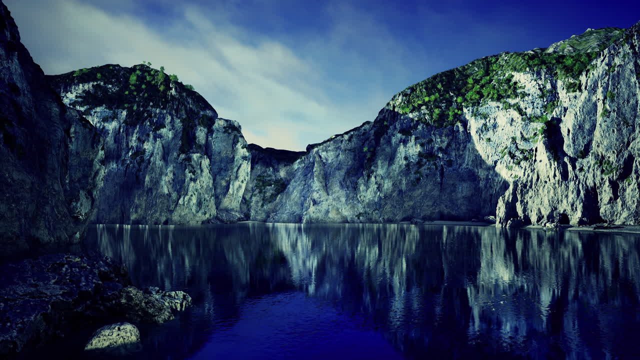 Majestic cliffs reflect in serene waters under a stunning twilight sky