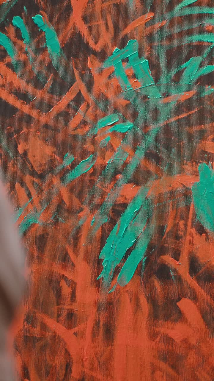 Artist's Hand Touching and Smearing Paint on Abstract Canvas