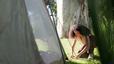 tent, nature and a woman with a camping setup