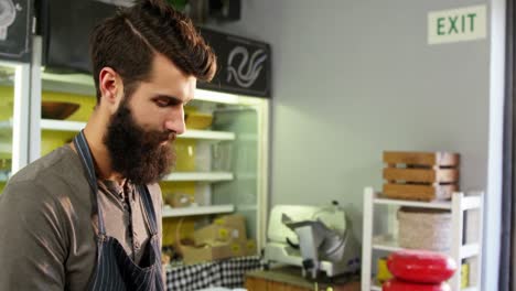 male staff making a checklist at counter