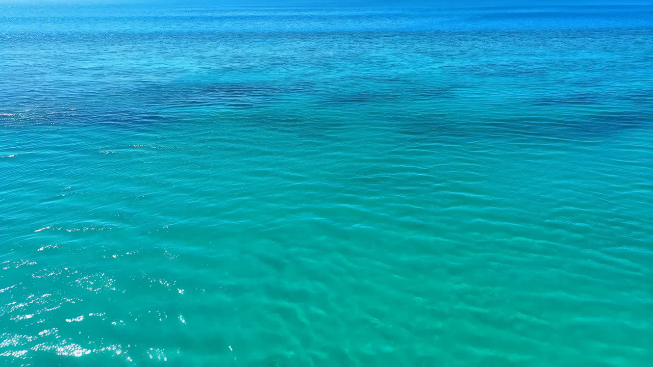 Vibrant Turquoise Ocean Water Under a Blue Sky