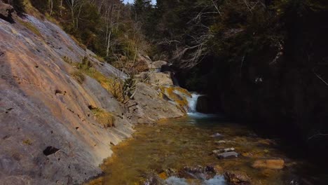 close up drone flight in the waterfall of a small river, in the spanish pyrenees