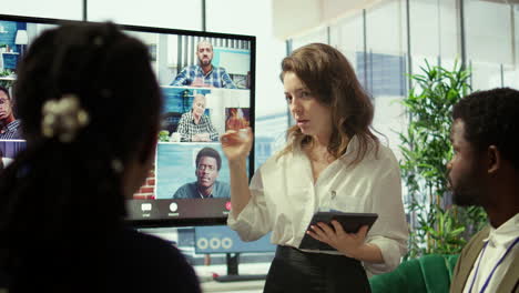 employees attending an online remote videocall meeting with general manager